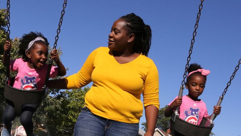 Cheree Moore enjoys an afternoon with twin daughters Auri, 3, left, and Camille at Longfellow Park on Sept. 12, 2016 in Oak Park, Ill. (Antonio Perez/Chicago Tribune/TNS)