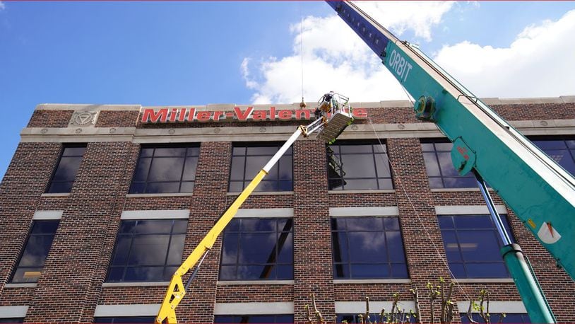 The Miller Valentine firm sign being installed at 409 E. Monument Ave., the firm’s new location. CONTRIBUTED