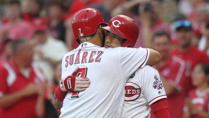 Eugenio Suarez and Jose Iglesias hug after Suarez hit a solo home run in the first inning against the Angels on Tuesday, Aug. 6, 2019, at Great American Ball Park in Cincinnati.