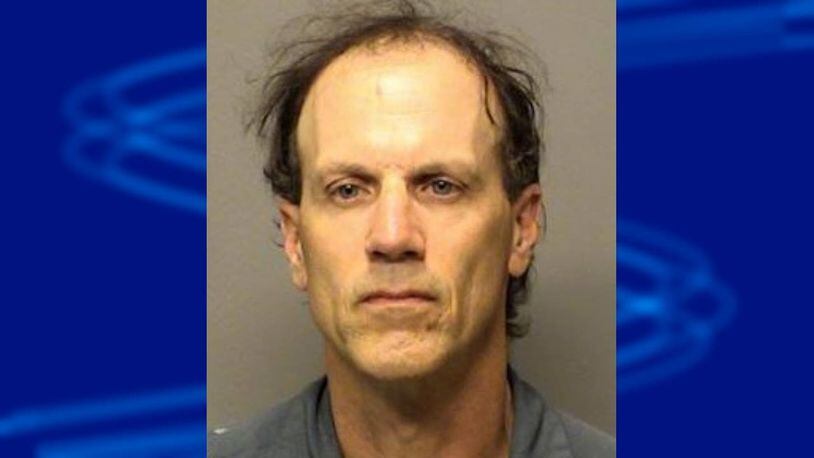 Ronald Johnson is accused of injuring a dog by hitting it in the eye socket with a log.
