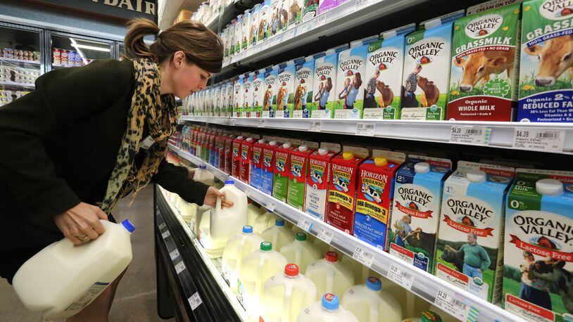2014 file photo: grocery employee stocks the milk cooler in Denver. AP