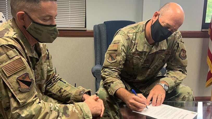 Col. Patrick Miller (right), 88th Air Base Wing and installation commander, and Chief Master Sgt. Jason Shaffer, 88 ABW command chief, are seen wearing the new Operational Camouflage Pattern uniform last August. U.S. AIR FORCE PHOTO/STACEY GEIGER