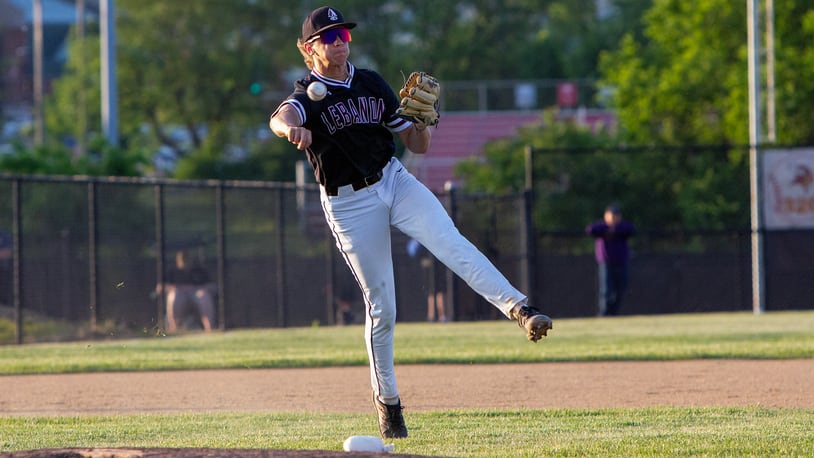Lebanon third baseman Grant Keffaber charges and makes a difficult play to throw out an Elder hitter during extra innings of Thursday night's 15-inning District final won 6-2 by Elder at Princeton High School. Jeff Gilbert/CONTRIBUTED