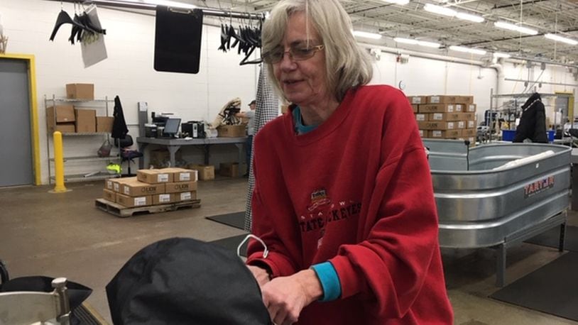 Riverside resident Cindy Baker, a Lion Apparel tester and sewing operator, at work at Lion’s Janney Road facility. Lion is rebuilding and hiring new workers after suffering damage in the Memorial Day tornadoes. THOMAS GNAU/STAFF