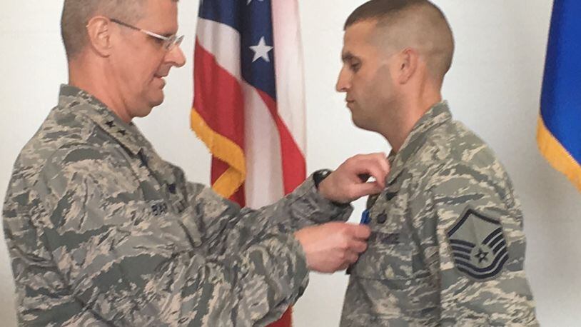 Ohio Adjutant General, Maj. Gen. Mark Bartman, pins the Ohio Cross on Master Sgt. Dallas Root of the 178th Wing in Springfield Saturday. This is Root’s second time earning the award for putting his life at risk to save another’s.