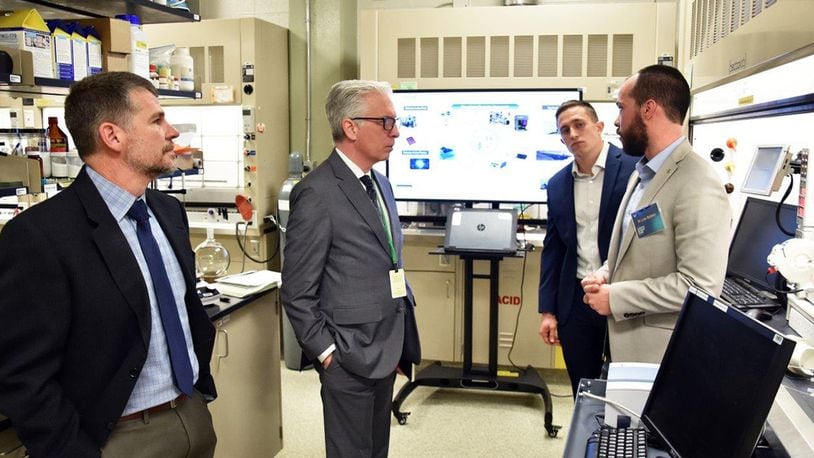 Ohio State University futurist Dr. David Staley talks with researchers in the chemistry foundry lab. Pictured from left to right are Dr. Russell Kurtz, Dr. David Staley, Dr. Luke Baldwin and Jordan Kaiser. (U.S. Air Force photo/Spencer Deer)