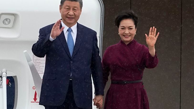 China's President Xi Jinping and his wife Peng Liyuan wave as they arrive Sunday, May 5, 2024 at Orly airport, south of Paris. French President Emmanuel Macron will seek to press China's Xi Jinping to use his influence on Moscow to move towards the end of the war in Ukraine, during a two-day state visit to France that will also see both leaders discuss trade issues. (AP Photo/Michel Euler, Pool)
