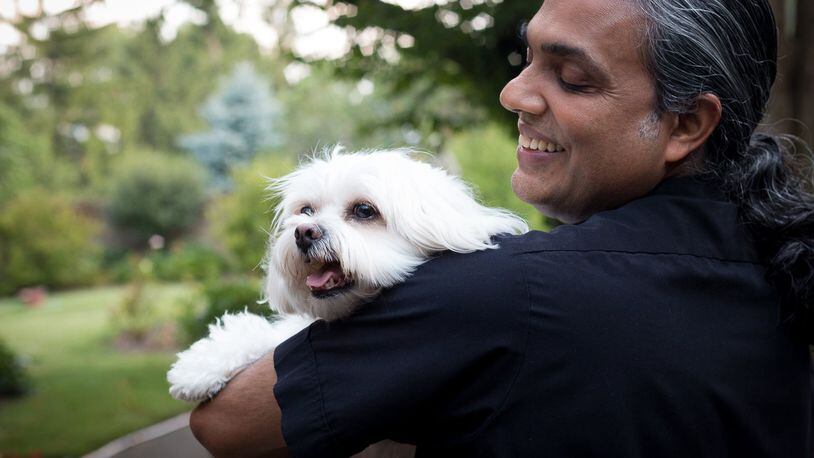 The Rev. Satish Joseph and his pet dog, Tutu. CONTRIBUTED