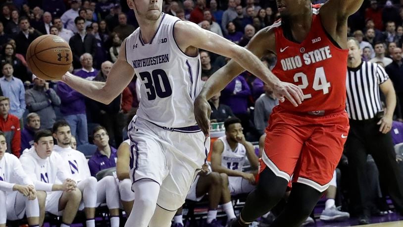 Northwestern guard Bryant McIntosh, left, looks to pass against Ohio State forward Andre Wesson during the second half of an NCAA college basketball game Wednesday, Jan. 17, 2018, in Rosemont, Ill. Ohio State won 71-65. (AP Photo/Nam Y. Huh)