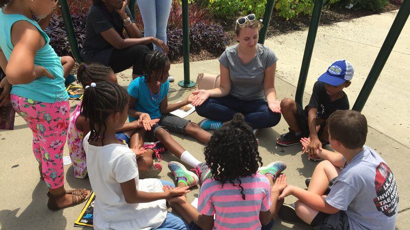 Bailey Plummer, a Summer Lunch Literacy intern from Bowling Green University, creates a teaching moment with teacher, Cynthia Shropshire s students, at their Cincinnati Zoo field trip.
