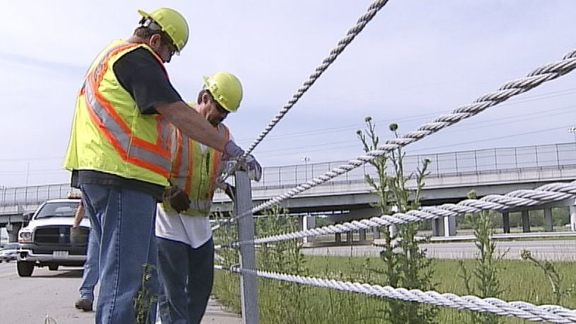 Ohio Department of Transportation workers repair safety cables on I-675 between U.S. 35 and North Fairfield Road on Monday, May 7. WHIO-TV PHOTO BY CHUCK HAMLIN