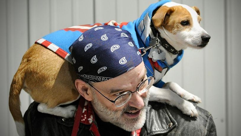 Tom Sobczak and his dog Tikis have fun at The Great Ohio Toy Show in Xenia. Loud fireworks disturb many pets, but animal experts say there are steps to keep them safe. MARSHALL GORBY/STAFF