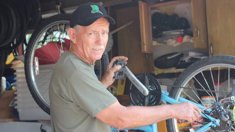 Charlie Gau works on a bike in West Carrollton. CONTRIBUTED