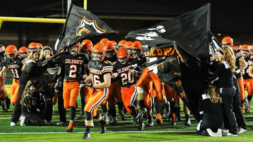 Coldwater’s Jared Pleiman (left), Neal Muhlenkamp (center) and Nate Rindler (right) lead the team on the field before a Div. V, Region 20 semifinal game on Saturday, November 12, 2016 at Sidney Memorial Stadium. Contributed Photo by Bryant Billing