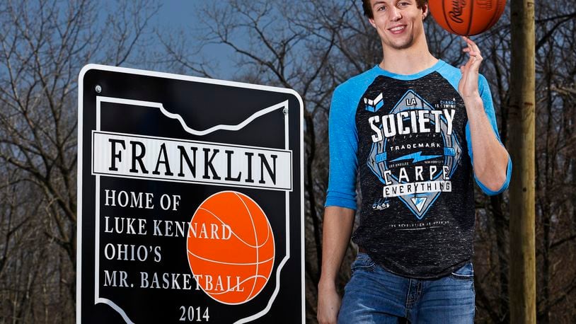 In this 2015 file photo, then-Franklin High School senior Luke Kennard stands next to one of the signs that were installed in Franklin honoring his Ohio Mr. Basketball honor. Around the time of the NBA draft, two of the five signs have been stolen forcing the city to take down the others. NICK GRAHAM/ STAFF