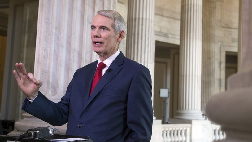 Sen. Rob Portman, R-Ohio, a member of the Senate Finance Committee, which writes tax policy, does a television news interview shortly before the panel begins work on the Republican plan to overhaul the nation’s tax code, on Capitol Hill in Washington, Monday, Nov. 13, 2017. The legislation in the House and Senate carries high political stakes for President Donald Trump and Republican leaders in Congress, who view passage of tax cuts as critical to the GOP’s success at the polls next year. (AP Photo/J. Scott Applewhite)