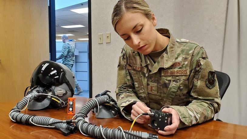 2nd Lt. (Dr.) Dominique O’Brien, project lead, Airman Sensing and Assessment Product Line, with the 711th Human Performance Wing’s Airman Systems Directorate, displays two devices her team used during flight tests in support of a request from the 20th Fighter Wing to provide assistance with assessing cabin pressure, oxygen concentrations and possible hypoxia-like symptoms reported by their F-16 pilots. One device is called the “Slam Stick,” (orange in color), which measures tri-axial acceleration – or acceleration in all three axes: X, Y and Z. The second device is called the Insta Pilot Breath Air Monitor, or IPBAM, (black device being held by Lt. O’Brien) which measures several critical parameters of the breathing gas delivered to the pilot. (U.S. Air Force photo/Bryan Ripple)