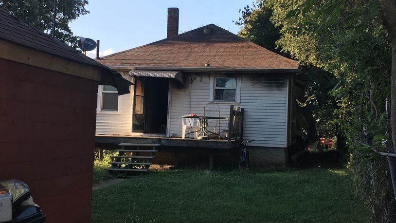 The back of a home in the 1700 block of Taylor Avenue in Middletown. The cause of the fire is still under investigation, but it appears a burning candle caught plastic on the wall on fire, according to the fire department. WAYNE BAKER/STAFF
