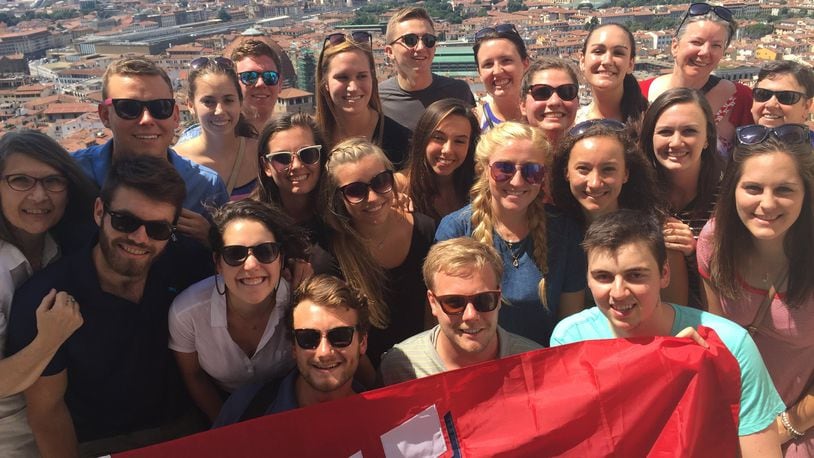 R. Darden Bradshaw (upper right in red sweater with sunglasses on her head) stands with University of Dayton students and instructor Laura Hume (far left) atop the Santa Maria del Fiore Cathedral in Florence, Italy, during a five-week interdisciplinary course last summer. CONTRIBUTED