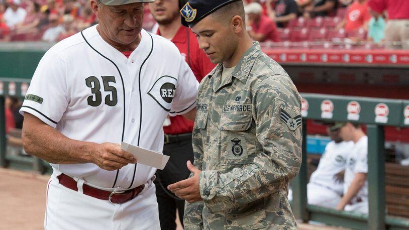 Senior Airman Abdiel Torres-Vega, 88th Security Forces Squadron entry controller, receives the line-up from the Red’s umpire during pregame ceremonies at the Great American Ballpark, Cincinnati, Aug. 10. (U.S. Air Force photo/Michelle Gigante)