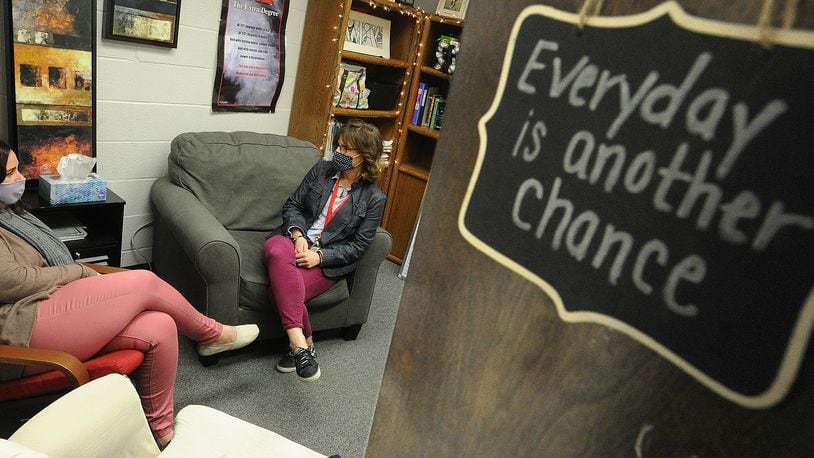 Troy MIddle School Guidance Counselors,  Jennifer Augustine, left, and Kelly Leganik, consult with each other Monday, March 15, 2021. Augistine has many positive signs hanging on her office door. MARSHALL GORBY\STAFF
