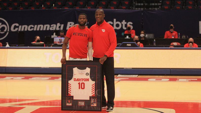 Dayton's Jalen Crutcher poses for a photo with coach Anthony Grant during a Senior Night ceremony before a game against Saint Louis on Senior Night on Friday, Feb. 19, 2021, at UD Arena. David Jablonski/Staff