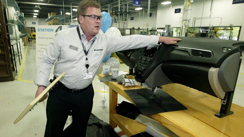 Chris Cooley, manufacturing engineering manager at Inteva Products, talks about how the skin is scored to hide an airbag in a SAAB SUV instrument panel made by Inteva in this 2011 file photo. FILE