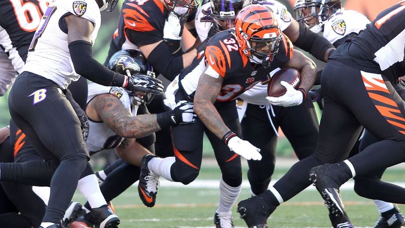 CINCINNATI, OH - JANUARY 3: Jeremy Hill #32 of the Cincinnati Bengals carries the ball during the fourth quarter of the game against the Baltimore Ravens at Paul Brown Stadium on January 3, 2016 in Cincinnati, Ohio. Cincinnati defeated Baltimore 24-16. (Photo by John Grieshop/Getty Images)