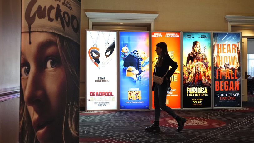 A visitor walks past advertisements for upcoming movies on the opening day of CinemaCon 2024 at Caesars Palace, Monday, April 8, 2024, in Las Vegas. The four-day convention of the National Association of Theatre Owners (NATO) runs through Thursday. (AP Photo/Chris Pizzello)