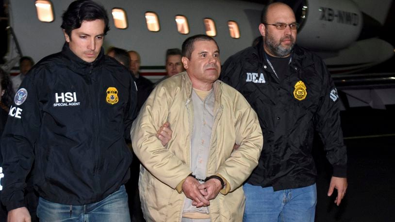 FILE - Authorities escort Joaquin "El Chapo" Guzman from a plane to a waiting caravan of SUVs at Long Island MacArthur Airport, in Ronkonkoma, N.Y., Jan. 19, 2017. Guzmán wrote a letter to District Court Judge Brian M. Cogan in the Eastern District of New York in late March 2024, claiming he cannot get phone calls or visits in the maximum security U.S. prison where he is serving a life sentence. (U.S. law enforcement via AP, File)