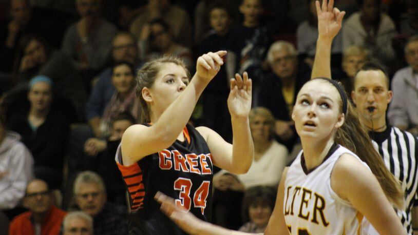 Beavercreek’s Rachel Mitchell (left) launches a 3-point shot over Alter defender Maddie Bazelak during a girls high school basketball game at Alter on Monday, Dec. 30, 2013. MARC PENDLETON / STAFF