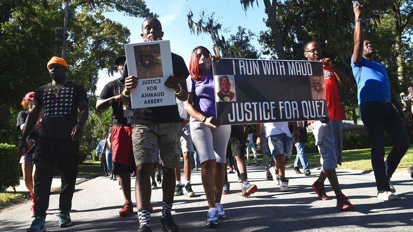 In this Tuesday, May 5, 2020, photo, a crowd marches through a neighborhood in Brunswick, Ga. They were demanding answers in the death of Ahmaud Arbery. An outcry over the Feb. 23 shooting of Arbery has intensified after cellphone video that lawyers for Arbery's family say shows him being shot to death by two white men. (Bobby Haven/The Brunswick News via AP) (Bobby Haven/AP)