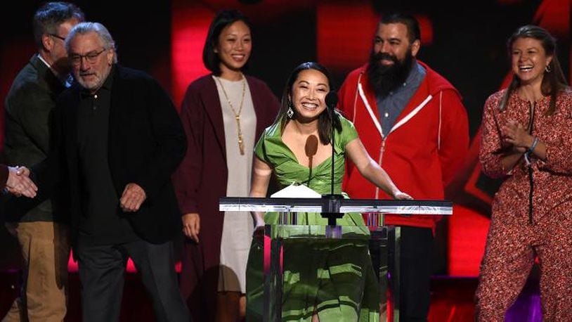 Lulu Wang, center, accepts the award for best feature for "The Farewell" at the 35th Film Independent Spirit Awards on Saturday, Feb. 8, 2020, in Santa Monica, Calif.