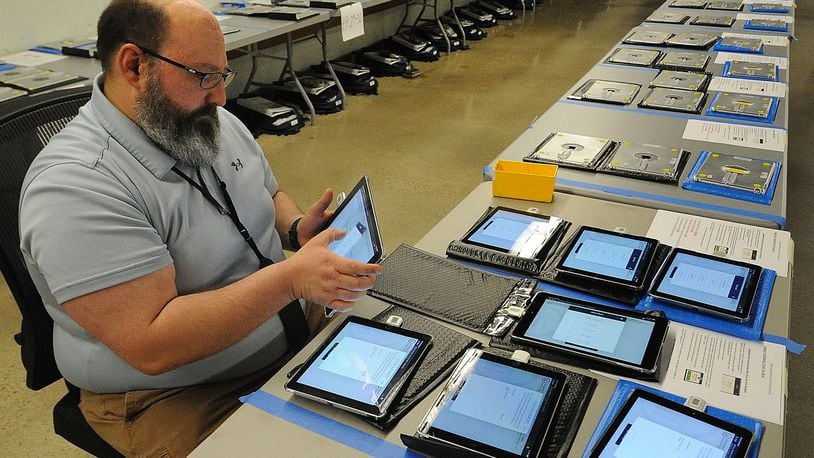 Montgomery County Board of Elections employee Adam Lawson prepares equipment Monday May 1, 2023 that will be used at polling locations in Tuesday’s primary election. Voting locations open at 6:30 a.m. across the state. MARSHALL GORBY\STAFF


