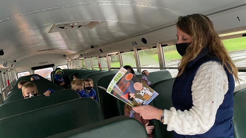 Springboro schools bus driver Karen Borgemenke takes the time to read to her students on the bus before the start of school. CONTRIBUTED