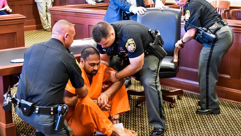 Gurpreet Singh, the West Chester man facing 4 counts of capital murder for the shooting death of 4 family members, was arraigned in Butler County Common Pleas Court Monday, August 5 in Hamilton. Singh fell to the ground while standing at the podium during the arraignment and was help up by Butler County Sheriff's deputies. NICK GRAHAM/STAFF