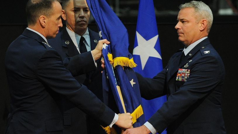 Lt. General Shaun Morris, left, passes the 88th Air Base Wing flag to Colonel Chris Meeker, during a change of command ceremony at the National Museum of the United States Air Force, Thursday, July 7, 2022.  MARSHALL GORBY