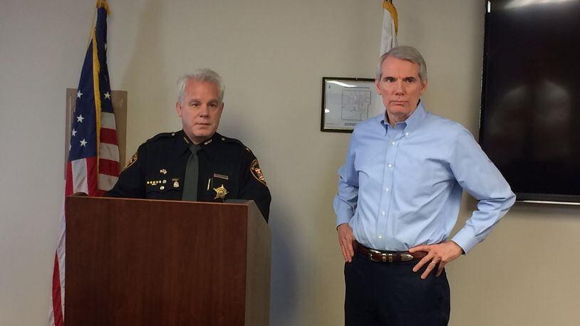 Sheriff Phil Plummer and U.S. Sen. Rob Portman, R-Ohio, discuss the drug crisis after a meeting Monday, Feb. 13, at the Montgomery County Sheriff’s Office. DARIN POPE / STAFF