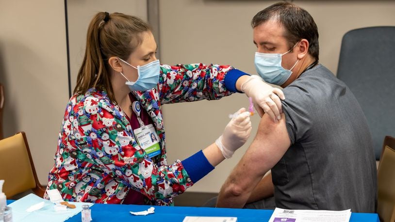 Dr. Jeremy Moore, the emergency department medical director at Miami Valley Hospital North, was one of the first Dayton-area residents to receive the federally approved coronavirus vaccine when he got his first shot on Dec. 22, 2020. Photo submitted by Premier Health.