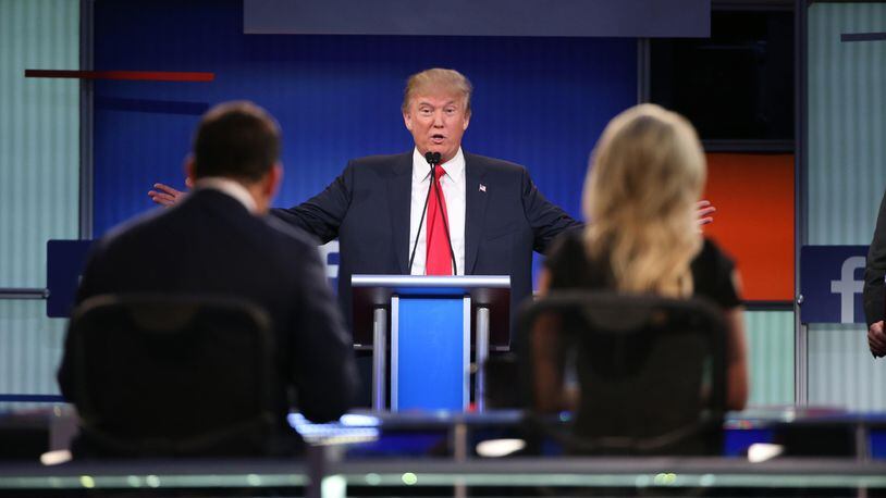 As Fox News moderators Brett Baier and Megyn Kelly look on, Donald Trump speaks during the Aug. 6 Republican presidential primary debate in Cleveland. Trump suggested after the debate that Kelly’s questioning of him during the debate was aggressive, saying "blood [was] coming out of her eyes, blood coming out of her wherever."  The remarks drew wide criticism and a disinvitation to a prominent conservative forum, however, didn't faze Trump's popularity.