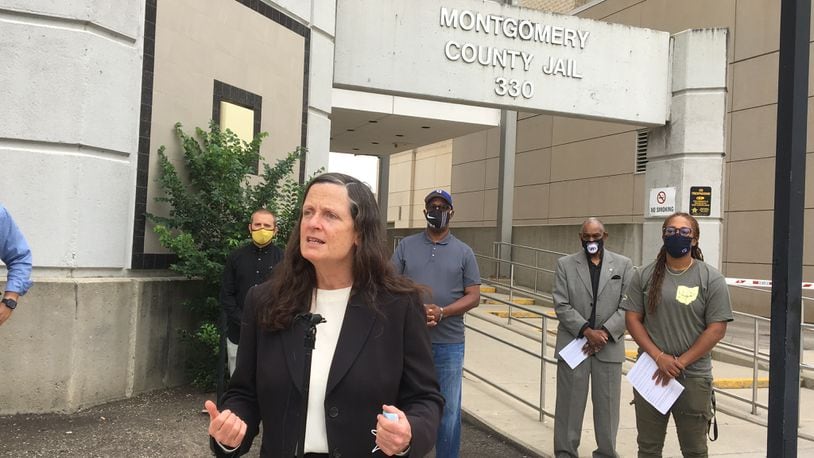 Montgomery County Public Defender T.G. Haire speaks in front of the county jail Tuesday. She and other community advocates are calling for the jail population to be lowered due to COVID-19.