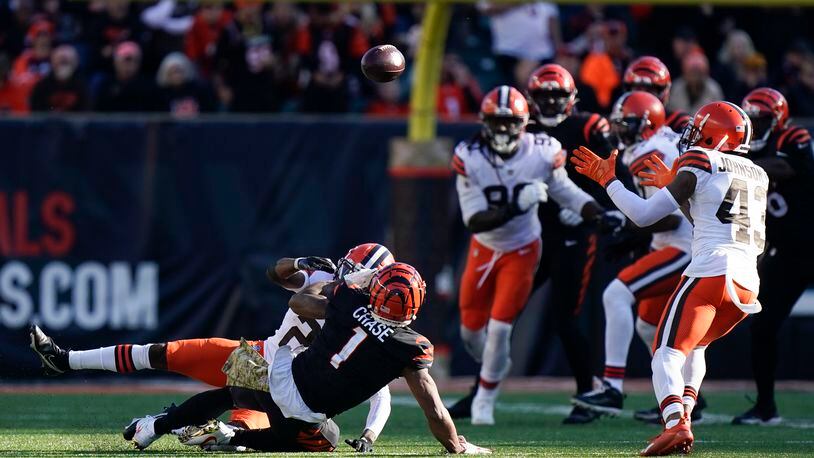 Cleveland Browns' John Johnson (43) recovers a fumble during the second half of an NFL football game against the Cincinnati Bengals, Sunday, Nov. 7, 2021, in Cincinnati. (AP Photo/Bryan Woolston)