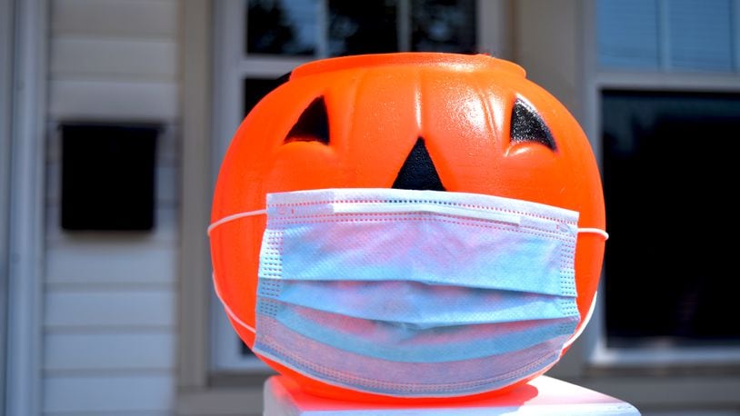 Health officials recommend people avoid door-to-door trick-or-treating or even "trunk-or-treating," by which children collect treats walking from car to car at gatherings in school or church parking lots. DAVID CARPIO / SHUTTERSTOCK