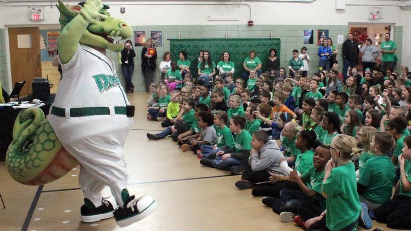 Dragons Baseball mascot Heater entertains students at Englewood Elementary School as part of an outreach to participate in the Dayton Dragons School Program. The incentive-based school fundraiser provides prizes to students and allows the schools to keep a portion of ticket sales to Dragons games. CHUCK HAMLIN / STAFF