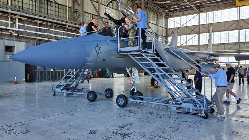 Members of the F-15 Program Office check out an F-15 aircraft during a ceremony on July 28 to mark 50 years of flight. U.S. AIR FORCE PHOTO/BRIAN BRACKENS