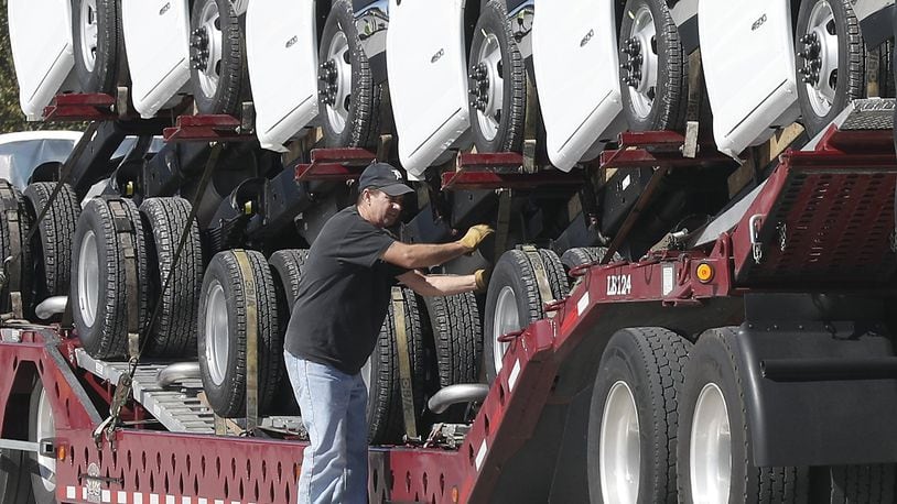 An employee of Wheeler Trucking loads GM vehicles built at Navistar’s Springfield onto a truck Tuesday, October 17, 2017. Wheeler started less than 10 years ago and grew from one employee to a $62 million a year company. In Springfield, they plan to start with 18 workers and grow to 102. Bill Lackey/Staff