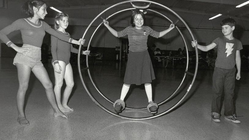 Mini circus members 13-year-old Janelle Russo and 11-year-old Beth Hurst with 10-year-old Tammy Spicer on German Wheel and 10-year-old Todd Jones. JOURNAL-NEWS PHOTO ARCHIVES
