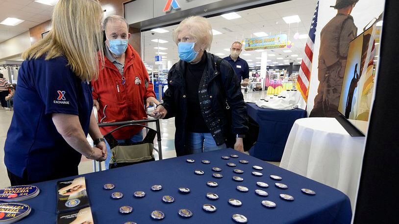 Sandra Church, acting store manager at the Base Exchange, chats with Air Force veteran Forrest Kerns and his wife, Phyllis, at Wright-Patterson Air Force Base on March 29. As part of National Vietnam War Veterans Day, Exchange managers presented Vietnam veterans with lapel pins and buttons to recognize, thank and honor those who served as they entered the store. U.S. AIR FORCE PHOTO/TY GREENLEES