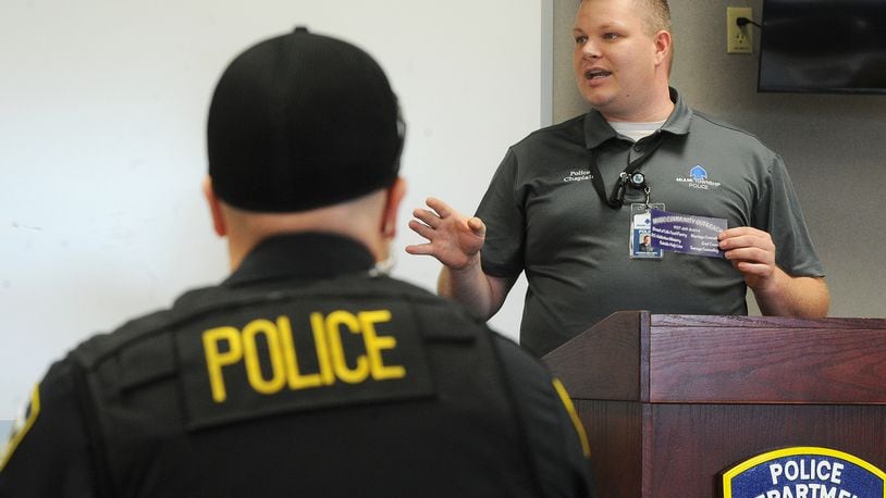 The Rev. Patrick Dell'Aria, pastor of Moraine Heights Baptist Church and chaplain for Miami Twp. Police Department, talks with police officers, Wednesday, May 12, 2021. MARSHALL GORBY/STAFF