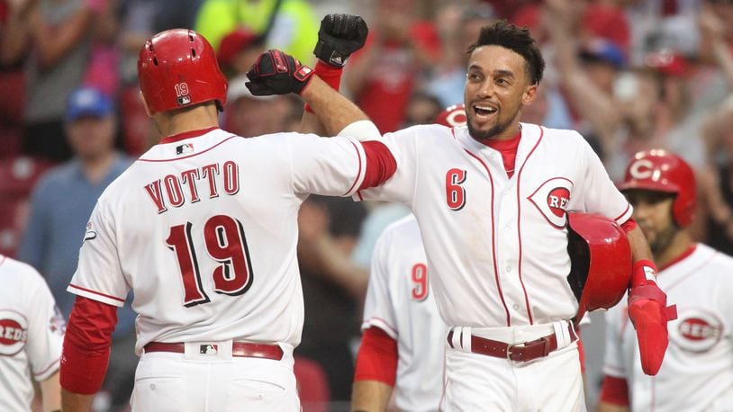 The Reds’ Joey Votto celebrates with Billy Hamilton after hitting a grand slam against the Tigers on Tuesday, June 19, 2018, at Great American Ball Park in Cincinnati. David Jablonski/Staff